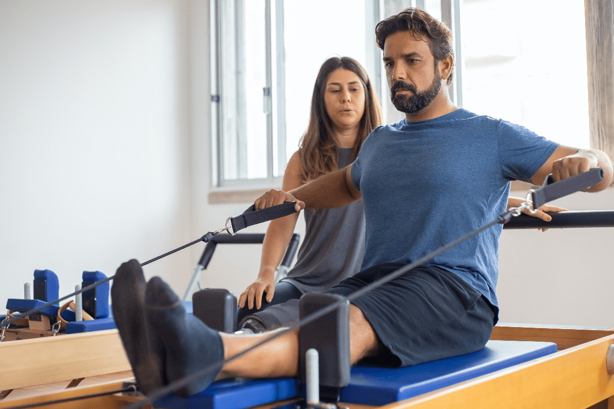 Man exercising in the presence of an instructor