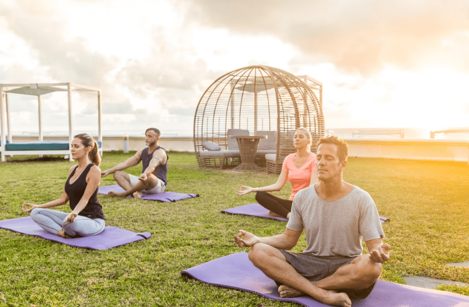 A Pilates yoga crossover class held outdoors