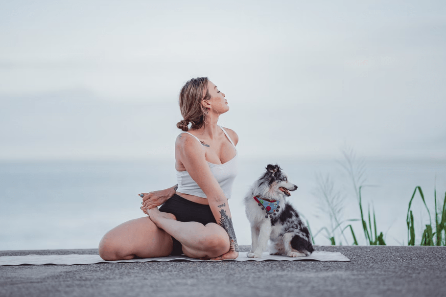 A woman cooling off after a fitness insanity workout with her dog