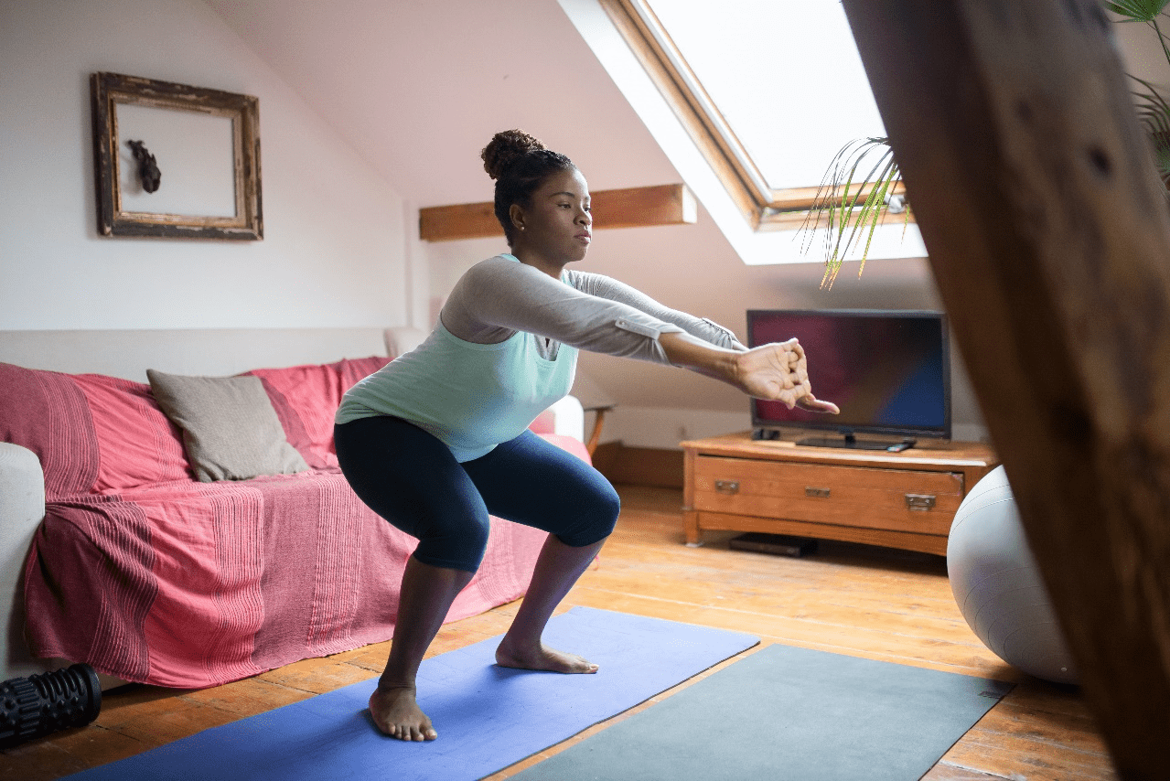 A woman doing squats at home