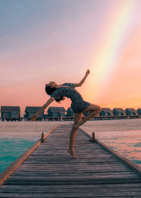  A woman attempting to do the flamingo yoga pose.