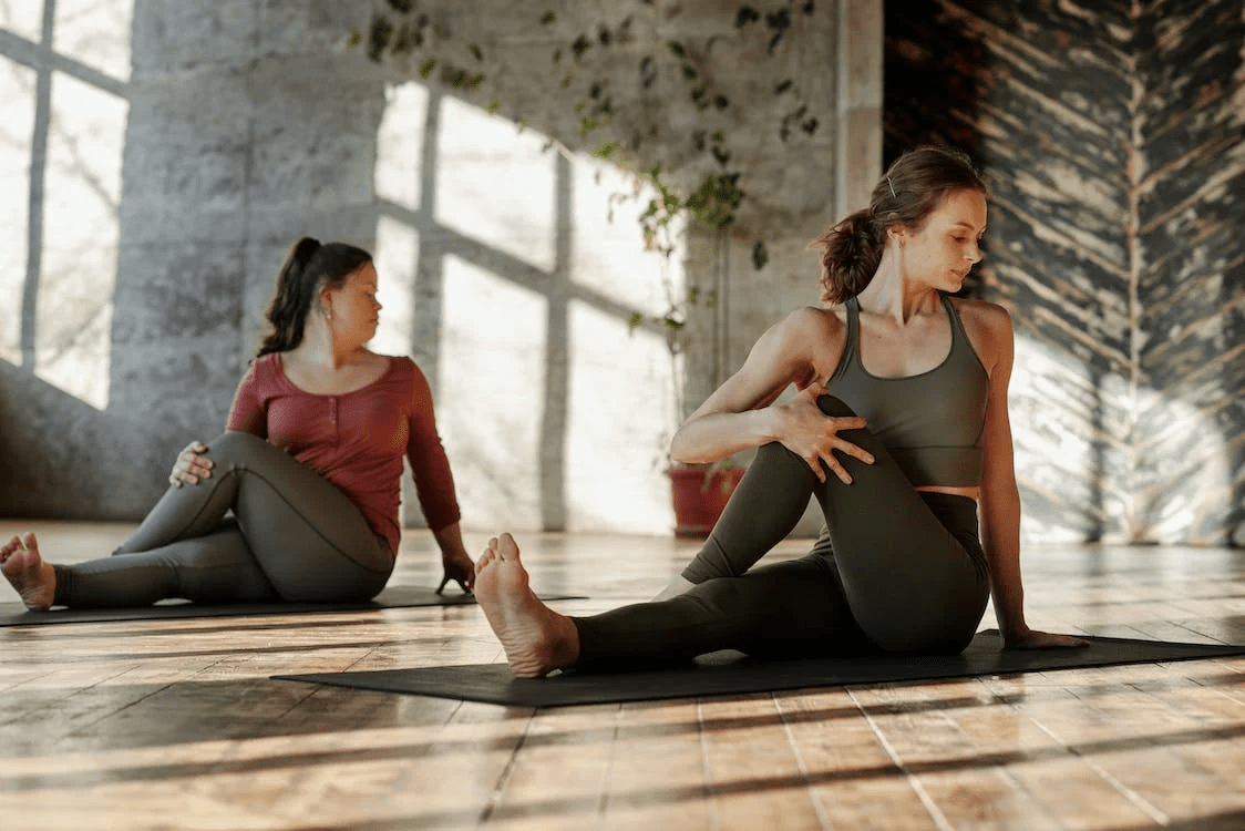 Two yoga practitioners in the middle of a session