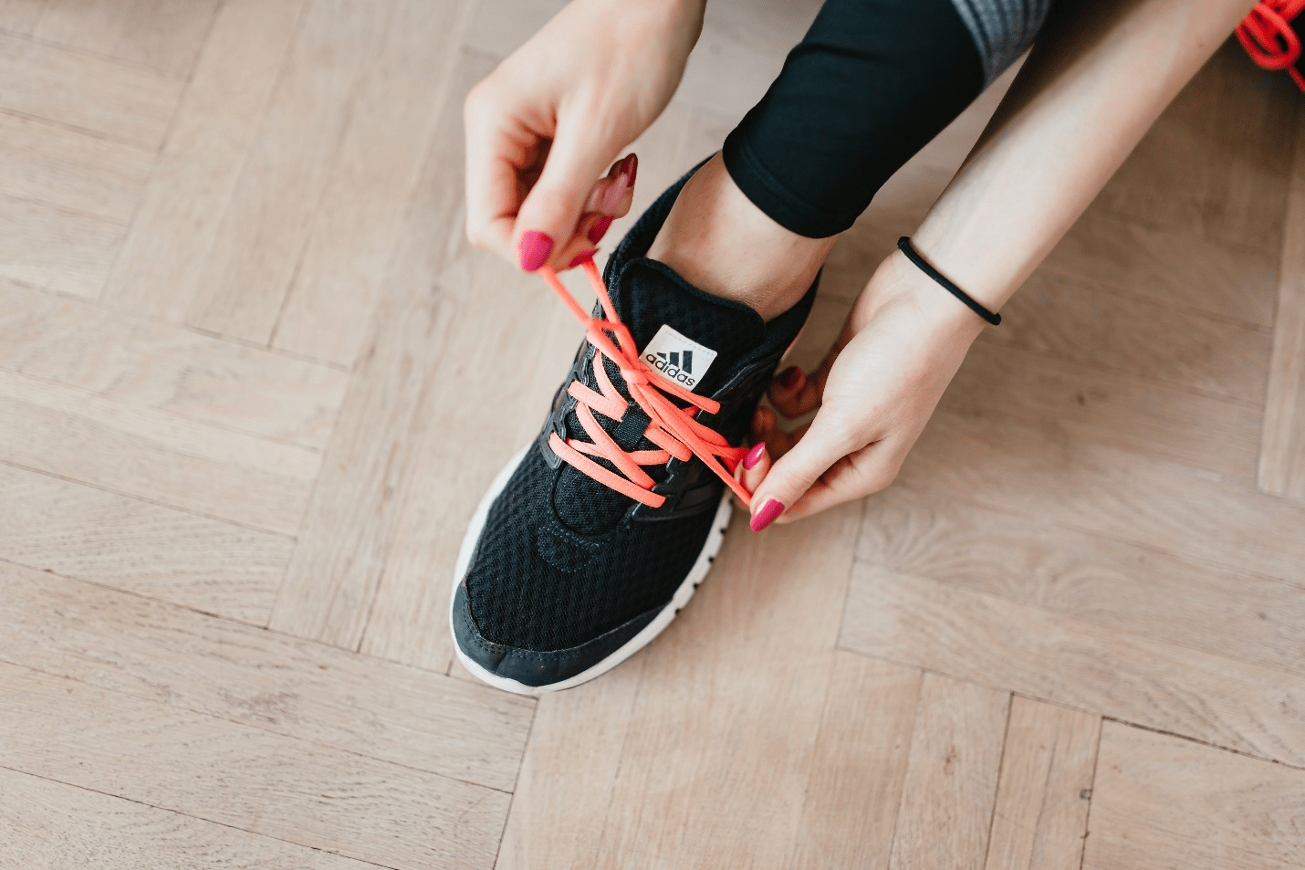 A woman tying her shoes