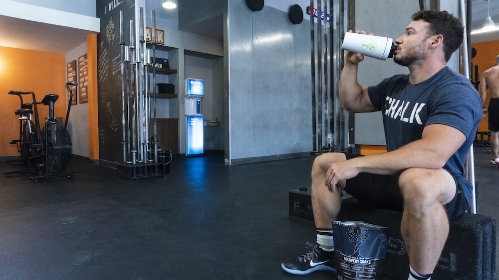 A gym instructor drinking a protein shake