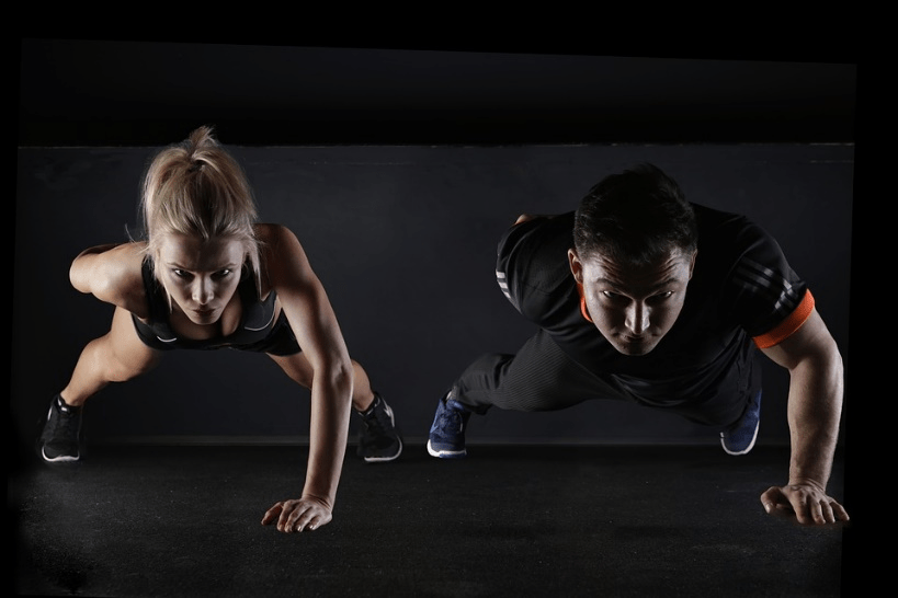 A couple busy strength training in a gym