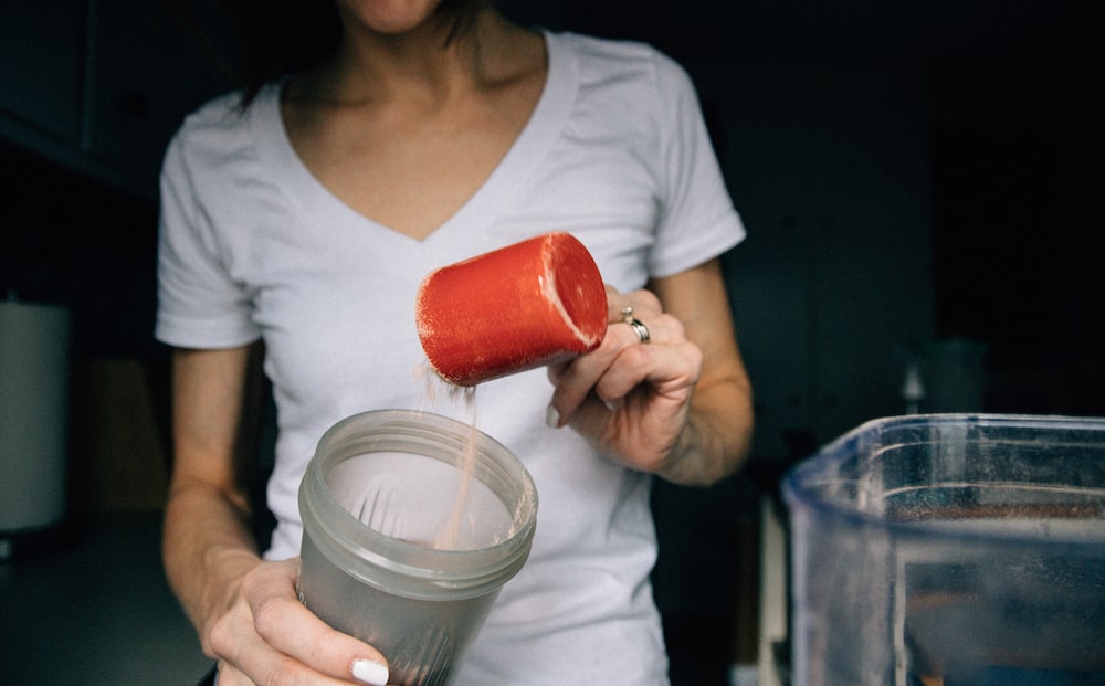 A girl making a protein shake before her yoga and dance class