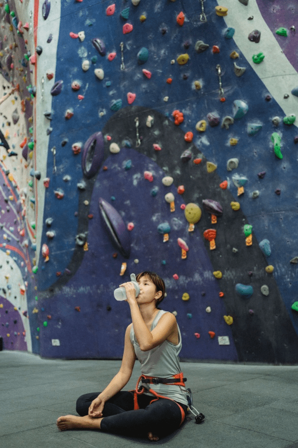 A woman drinking water mid-workout