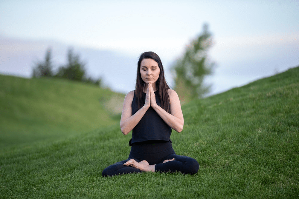 A woman meditating in a field