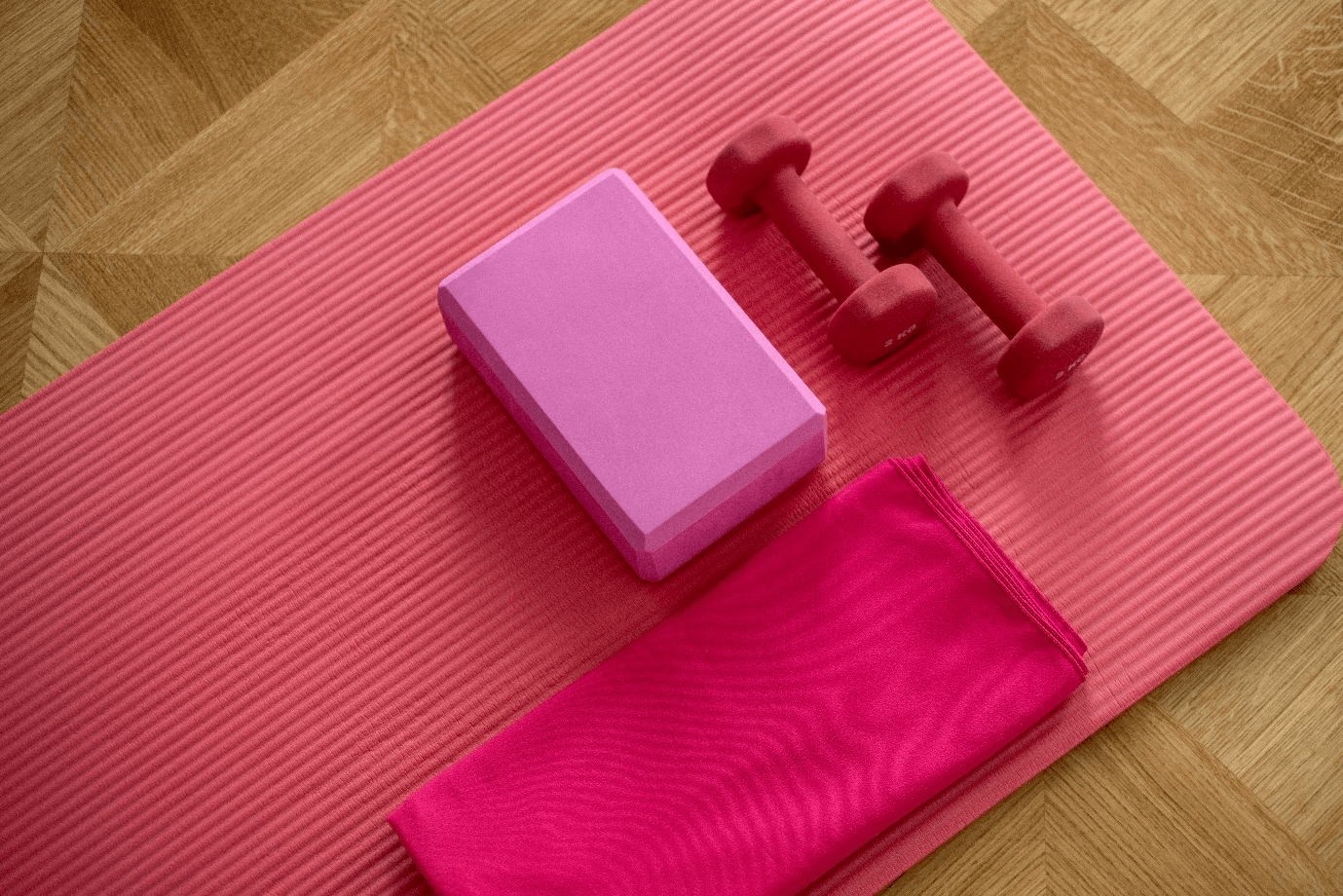 Pink yoga mat with dumbbells