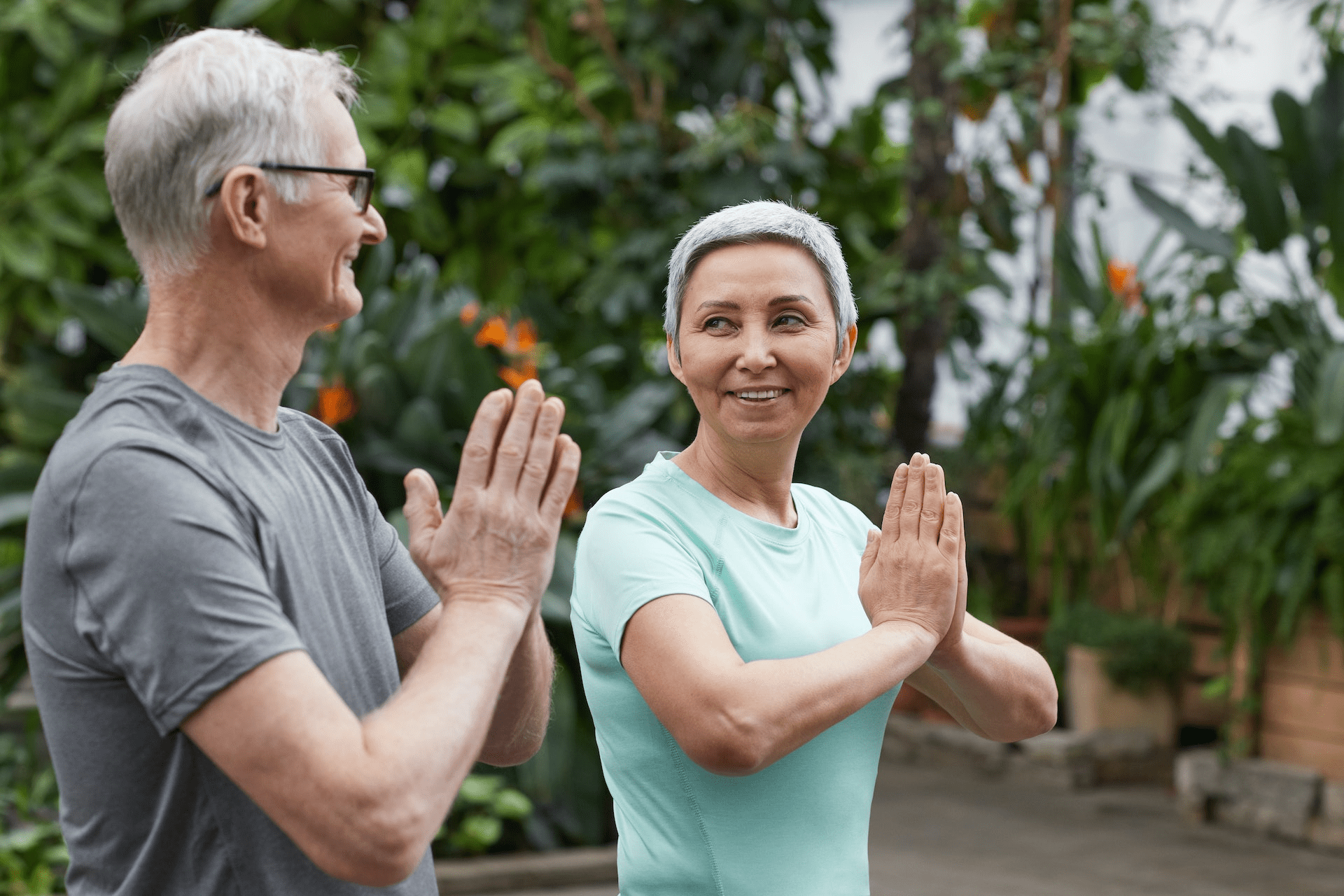 Couple smiling while doing a yoga pose