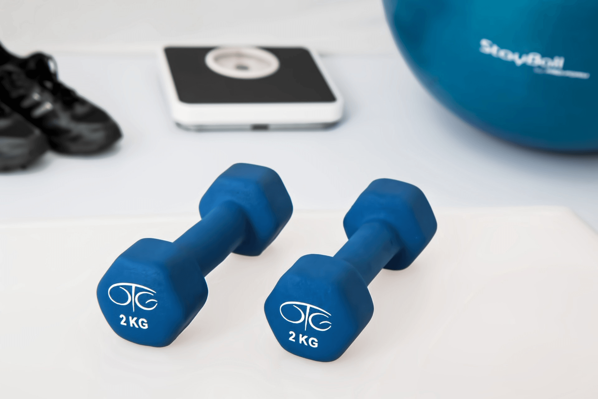 Blue-Colored Dumbbells on a White Surface