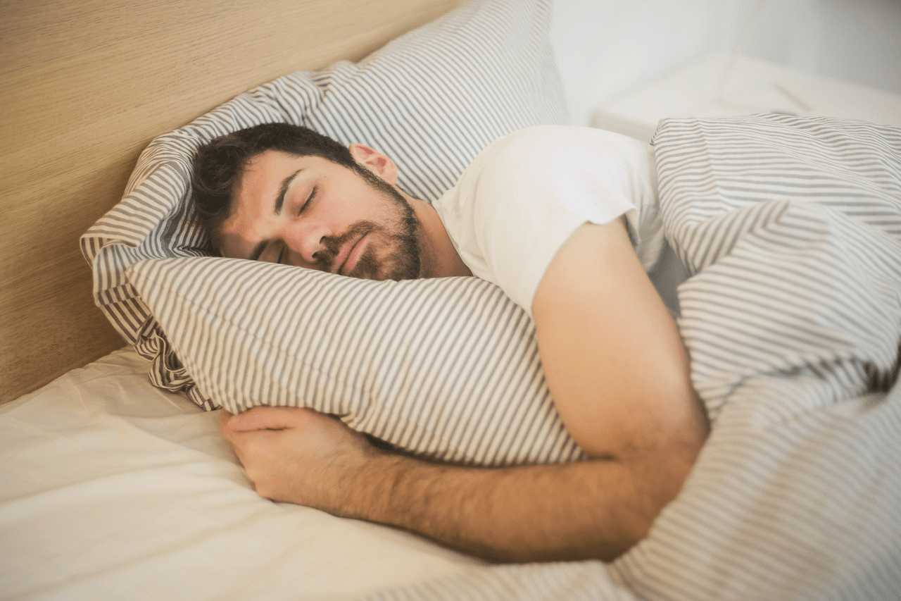 A Man Sleeping on a Bed